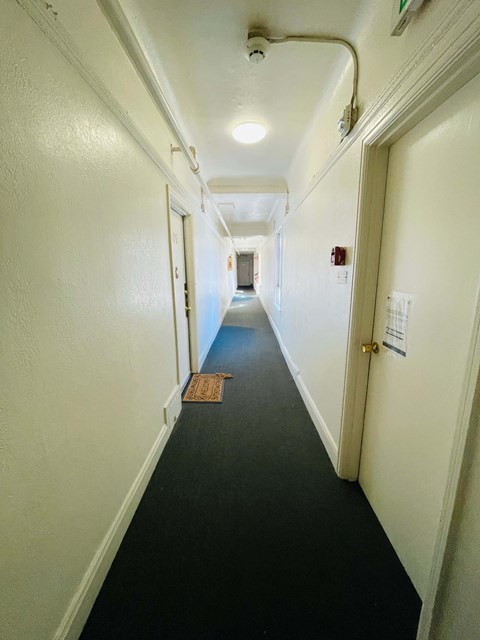 A long hallway with a door on the right.