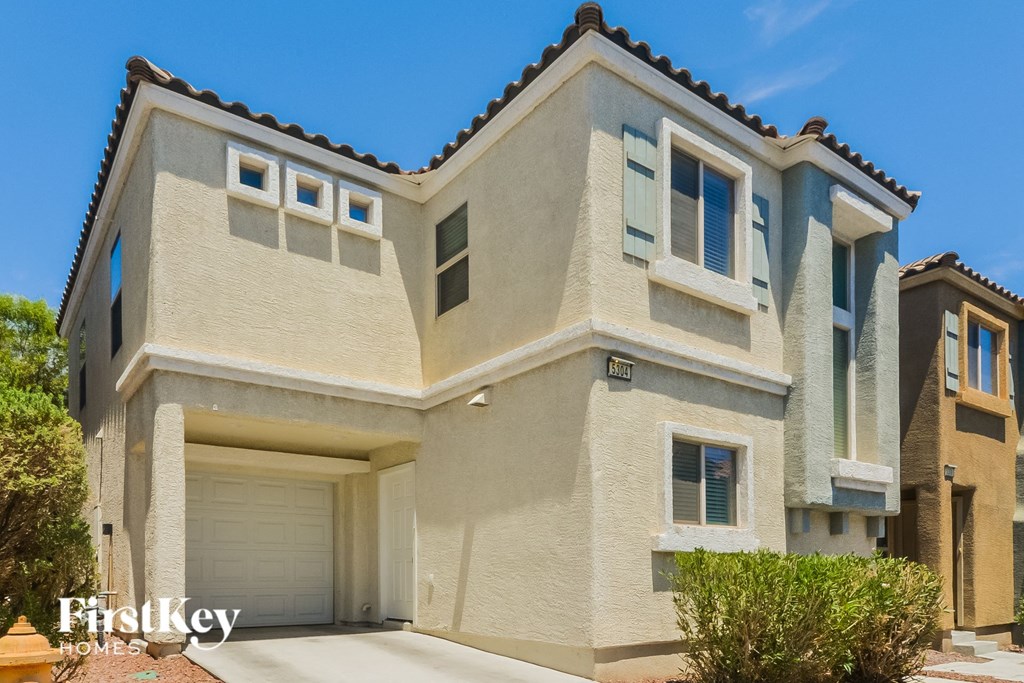 A modern house with a garage is for sale.
