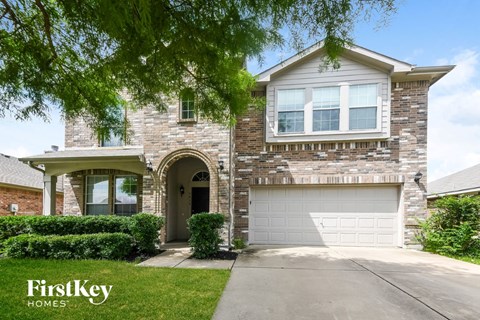 a brick house with a white garage door