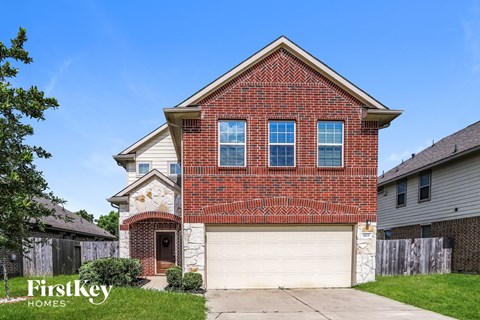 a brick house with a white garage door
