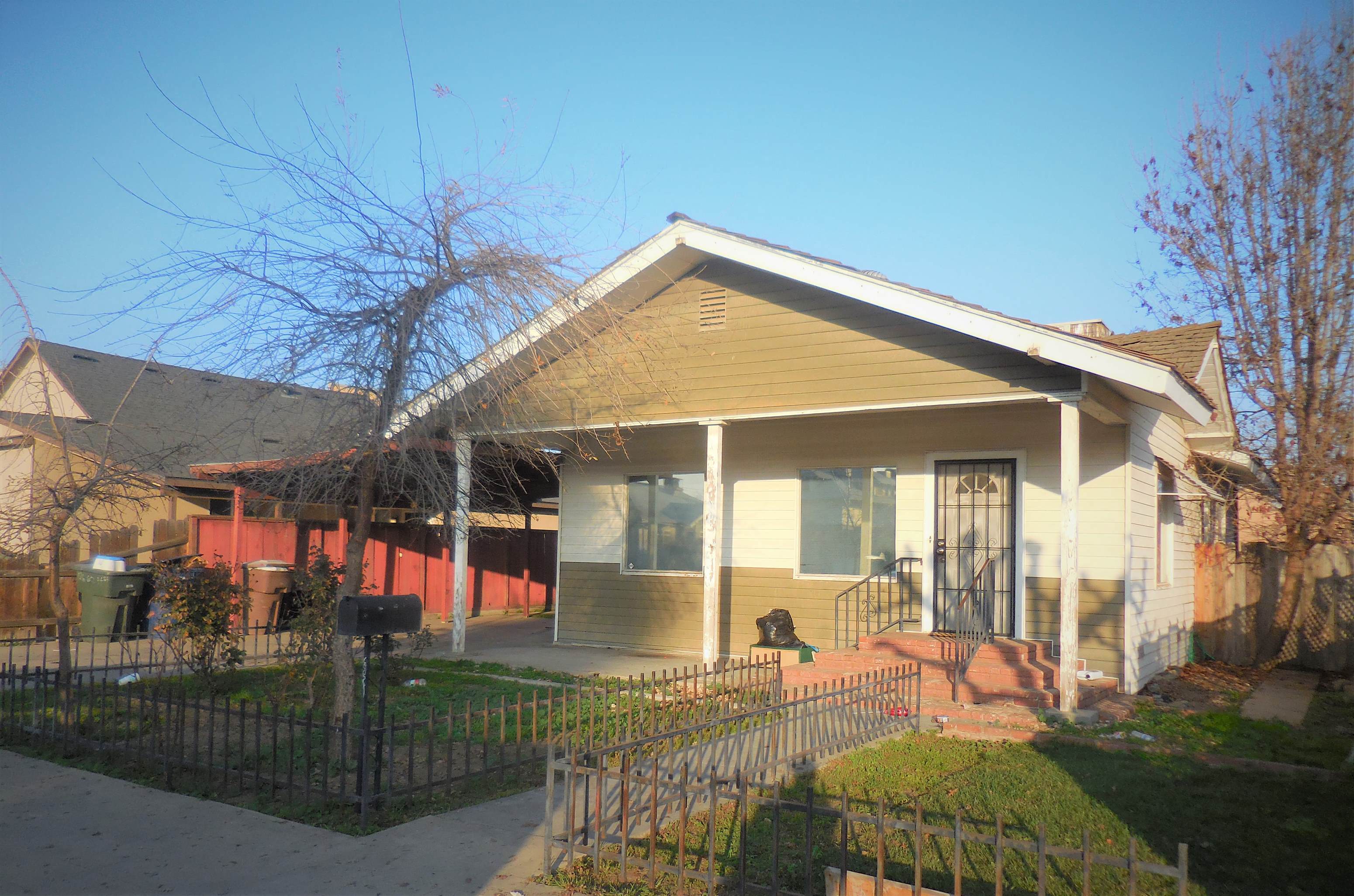 a house with a fence in front of it