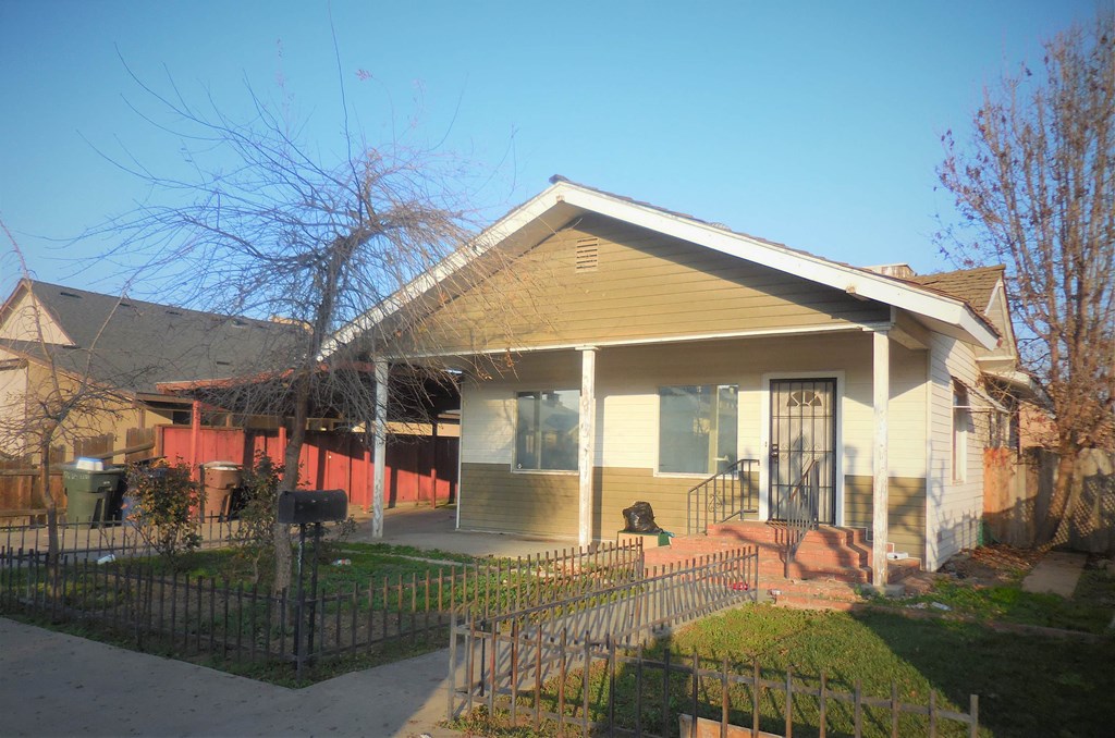 a house with a fence in front of it