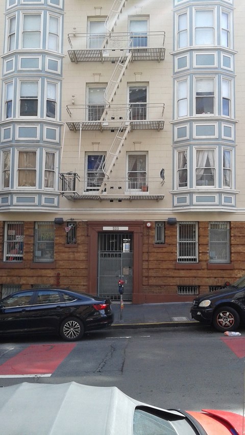 the apartment building has a fire escape on the side of it