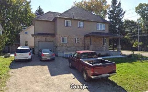 A house with a red truck parked in front.