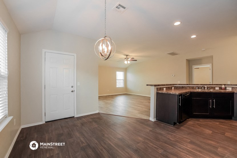 the view of the living room and kitchen from the dining room