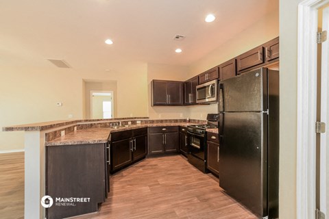 a kitchen with stainless steel appliances and a counter top