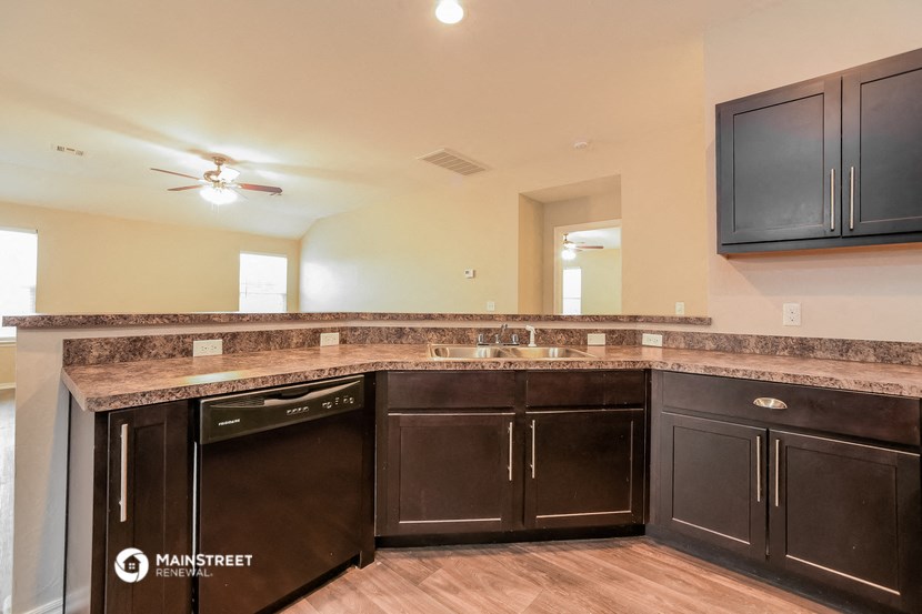 a kitchen with dark cabinets and a counter top