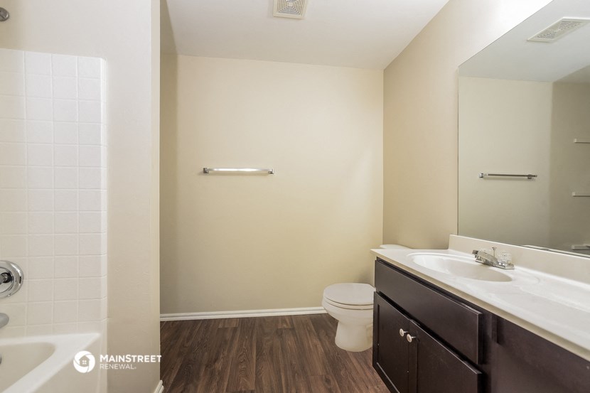 a bathroom with a toilet and a sink and a mirror
