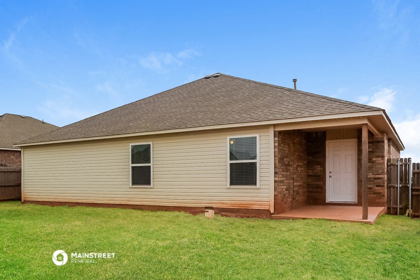 the front of a brick house with a garage door