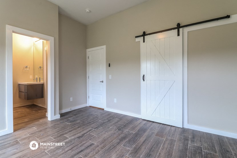 a bedroom with two closets and a door to a bathroom