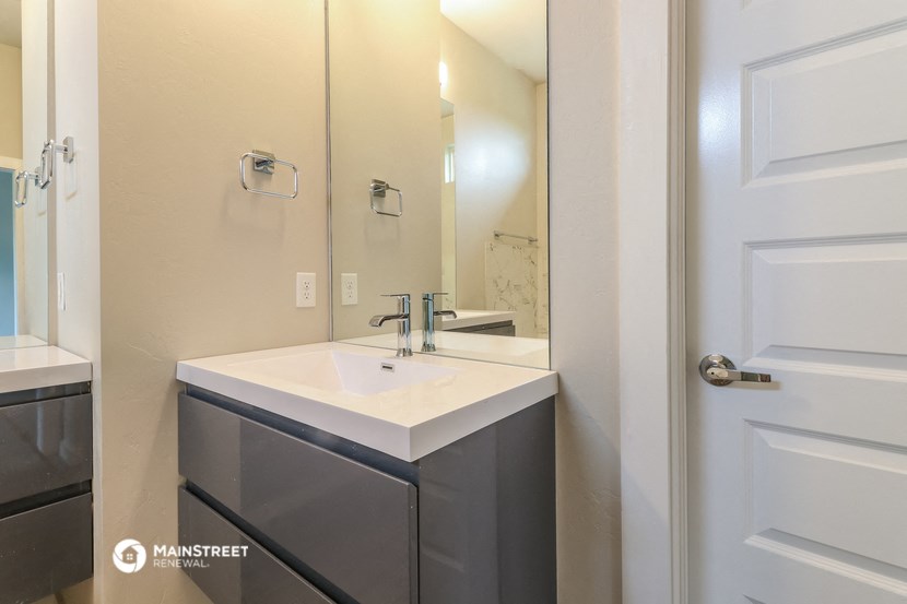 a small bathroom with a sink and a mirror