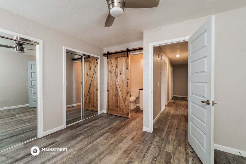 a bedroom with a closet and a bathroom with a sliding door