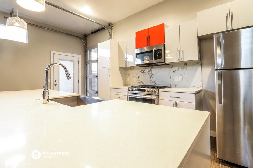 a kitchen with stainless steel appliances and a white counter top