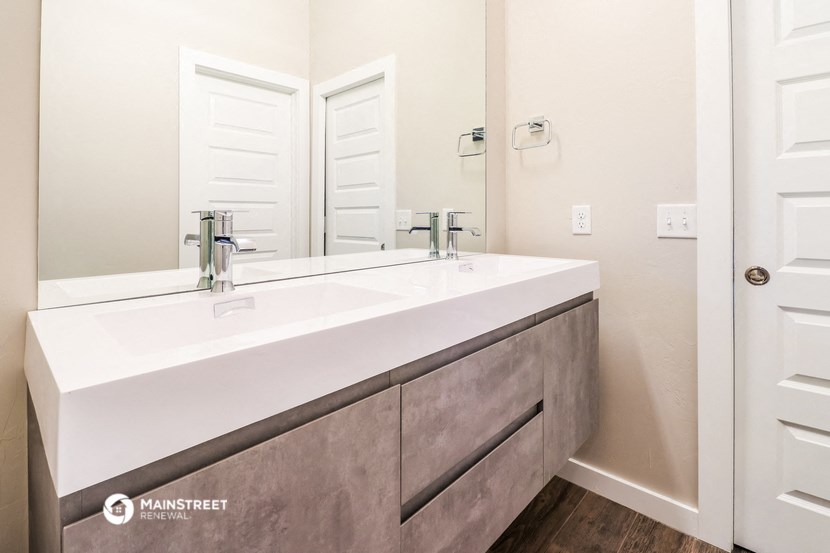 a bathroom with a large sink and a mirror