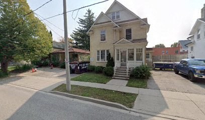 a yellow house on the corner of a street