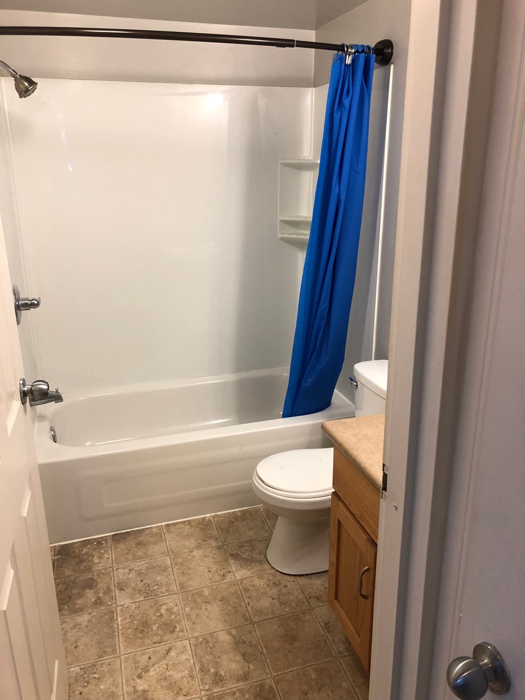 a bathroom with a toilet and a tub and a shower curtain