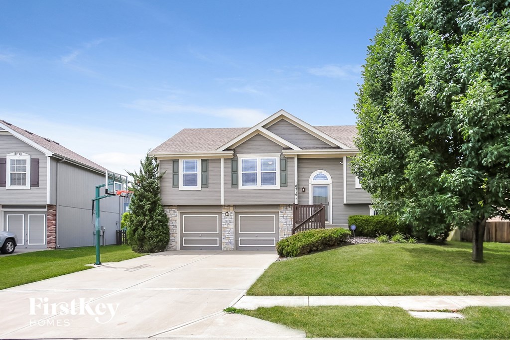 a home with a garage and a lawn