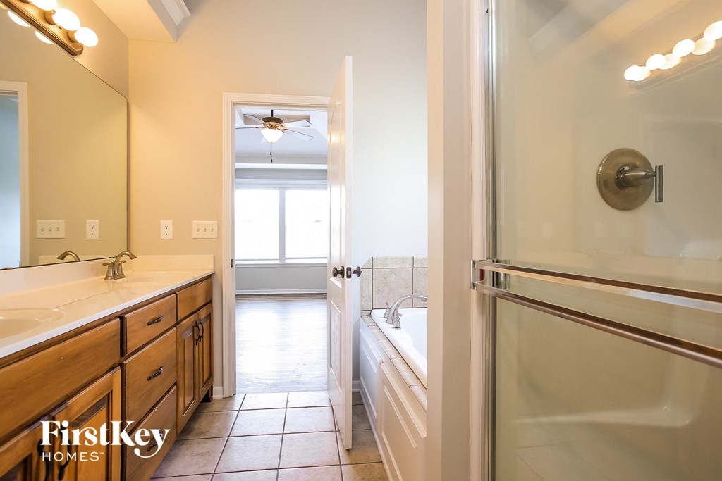 a bathroom with a sink and a shower and a tub