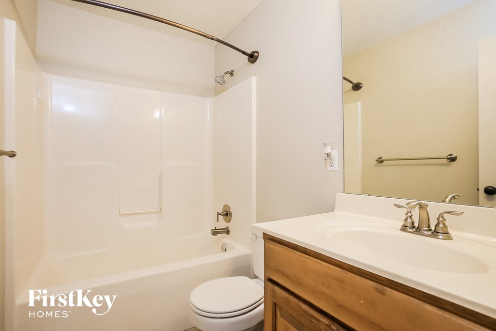 a bathroom with a sink and a toilet and a tub