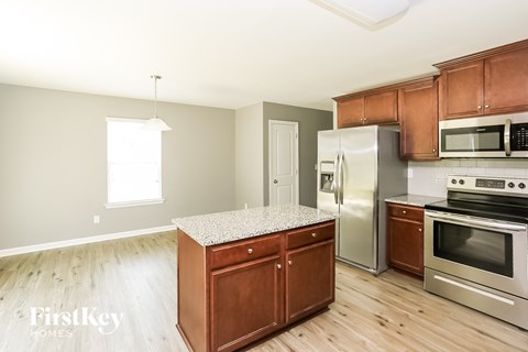 A kitchen with wooden cabinets and stainless steel appliances.