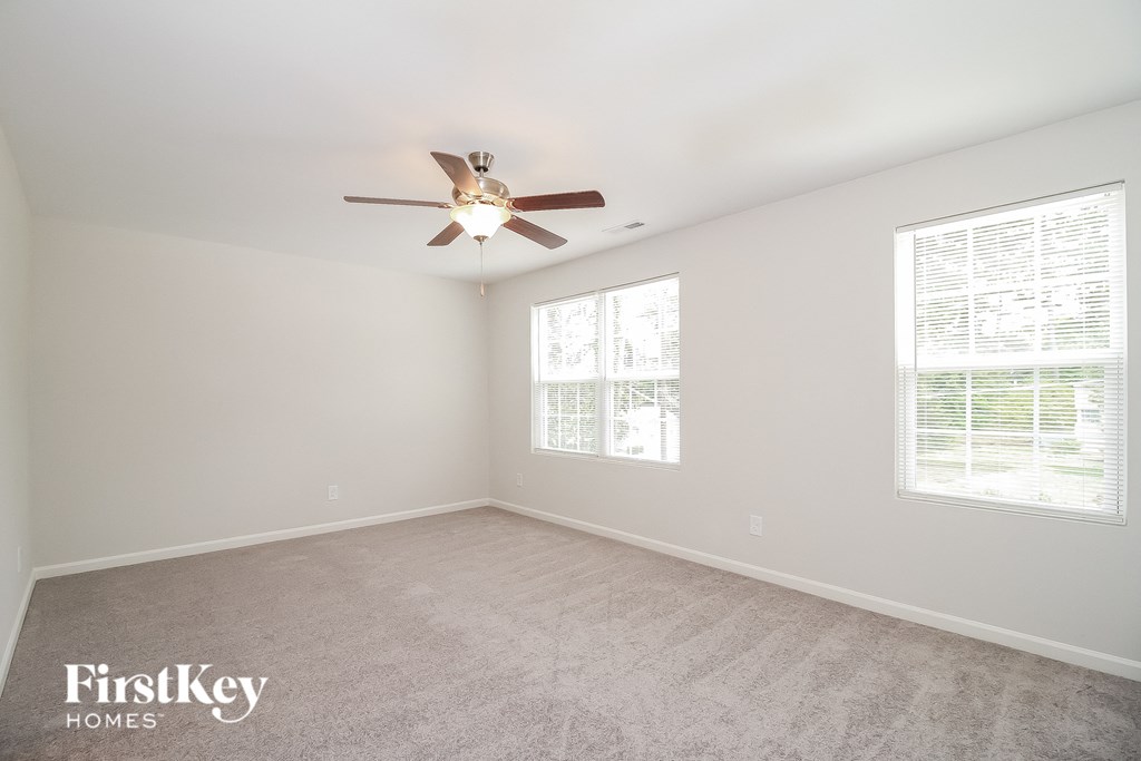 a living room with a ceiling fan and a window