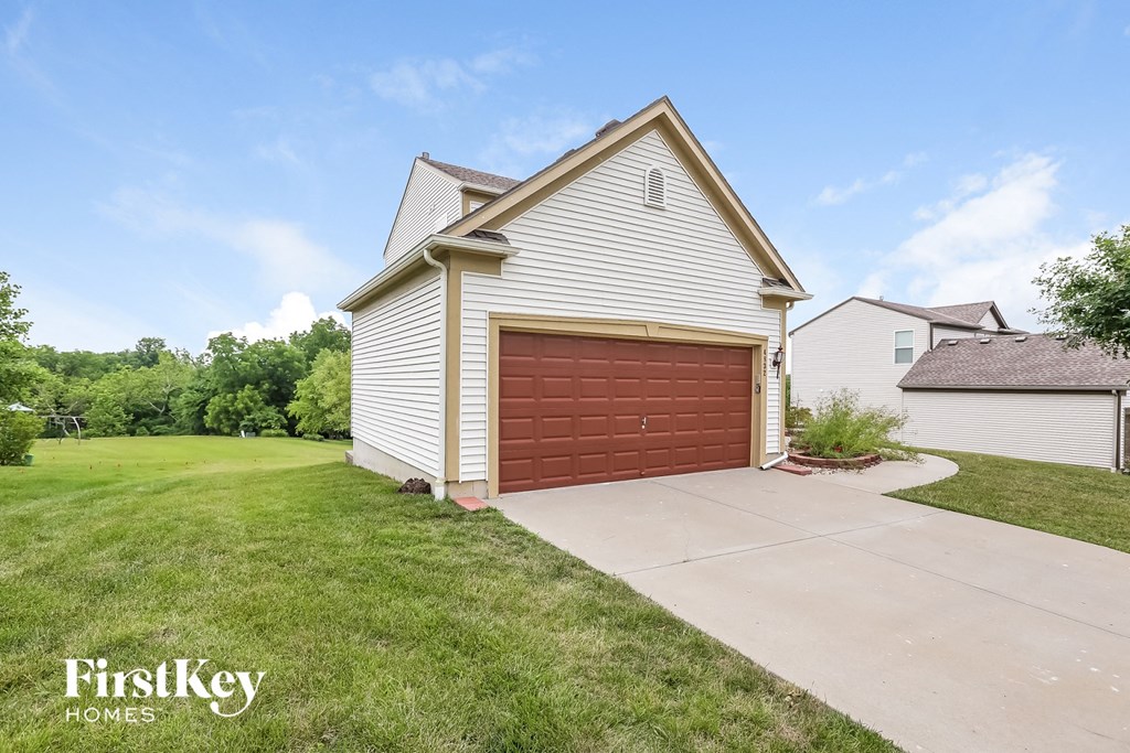 A house with a garage door is for sale by FirstKey Homes.