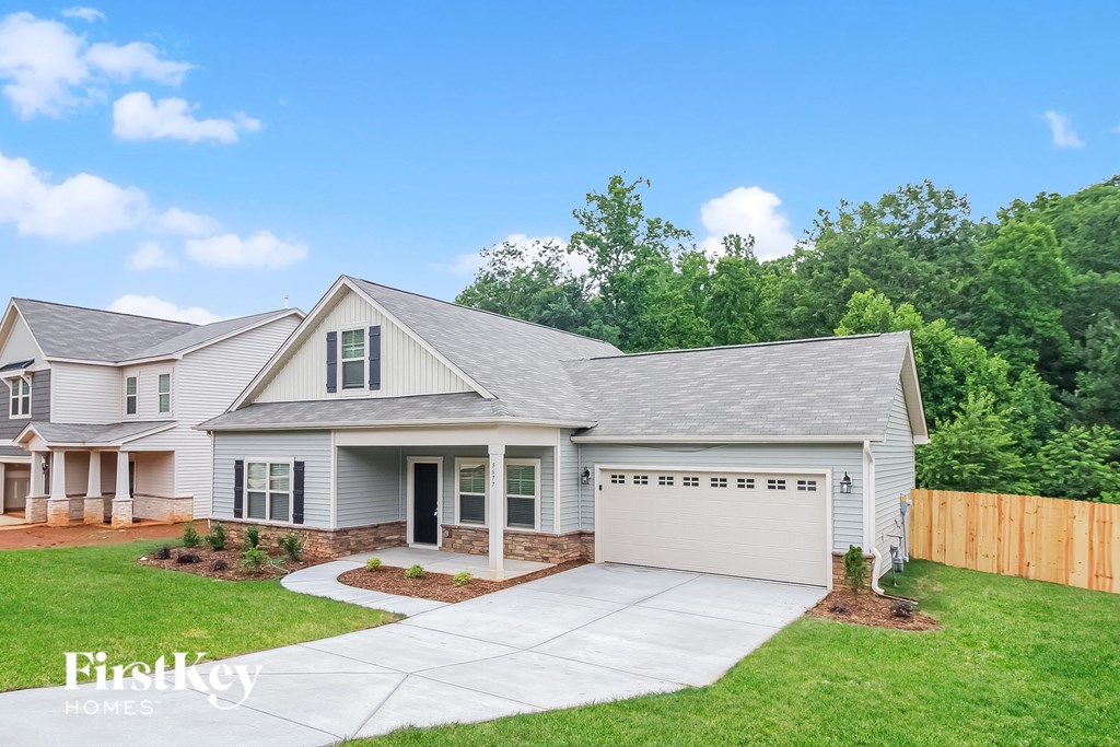 a white house with a lawn and a driveway