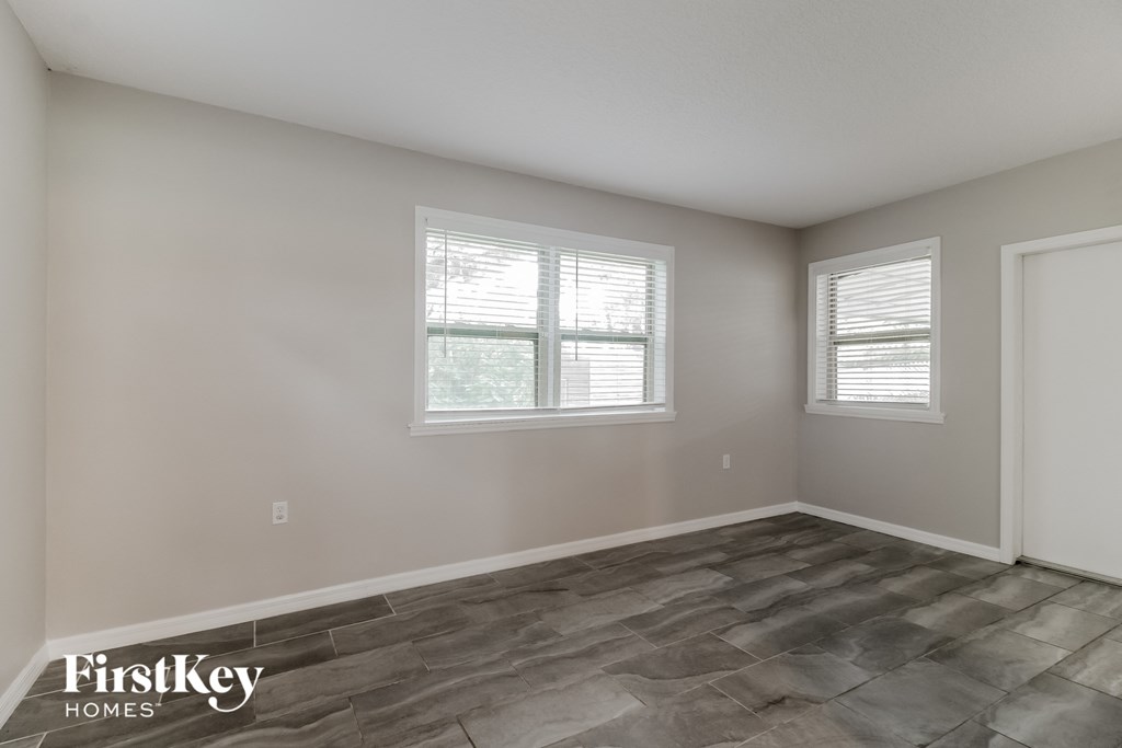 the living room of a home with a tile floor and a window