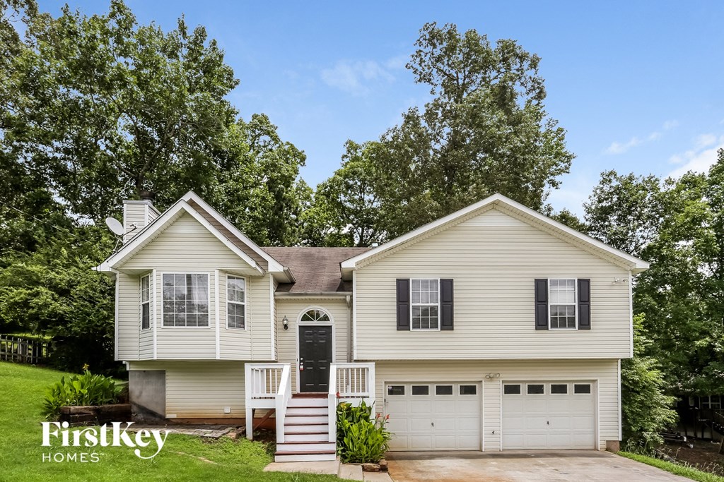 A two-story house with a garage is for sale.