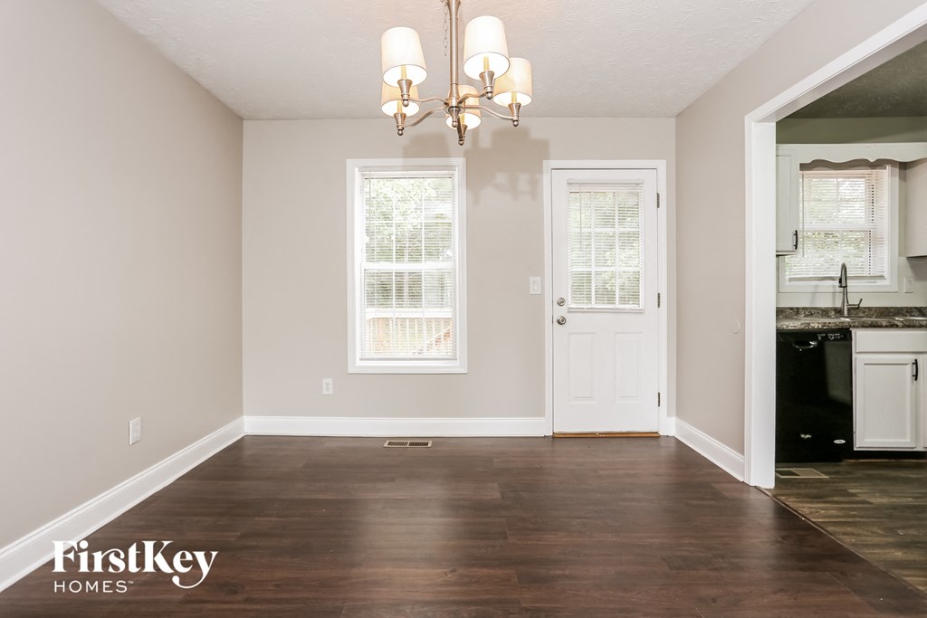 A room with a wooden floor and a chandelier.