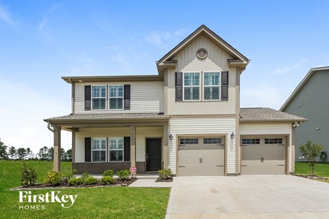 a house with two garage doors and a driveway