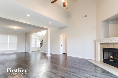 a living room with white walls and a fireplace