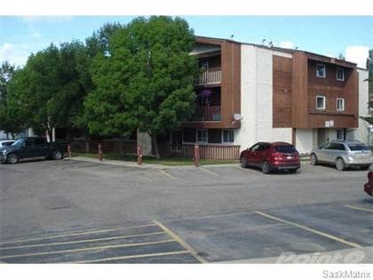 a parking lot with cars in front of a building