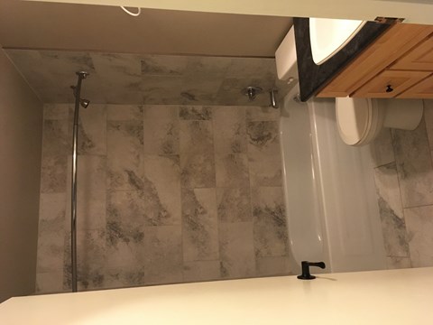 a small bathroom with a shower and a toilet