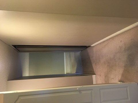 a view of the top of the closet with the door open