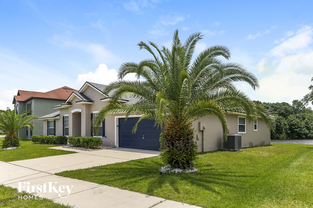 a palm tree in front of a house