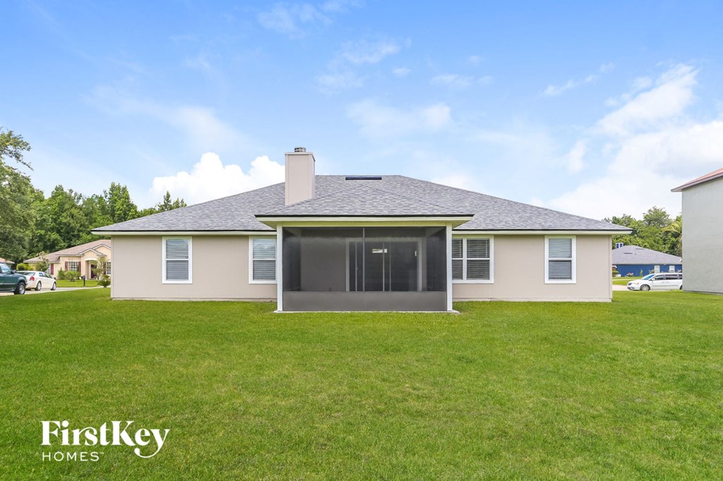 a home with a grass yard and a house