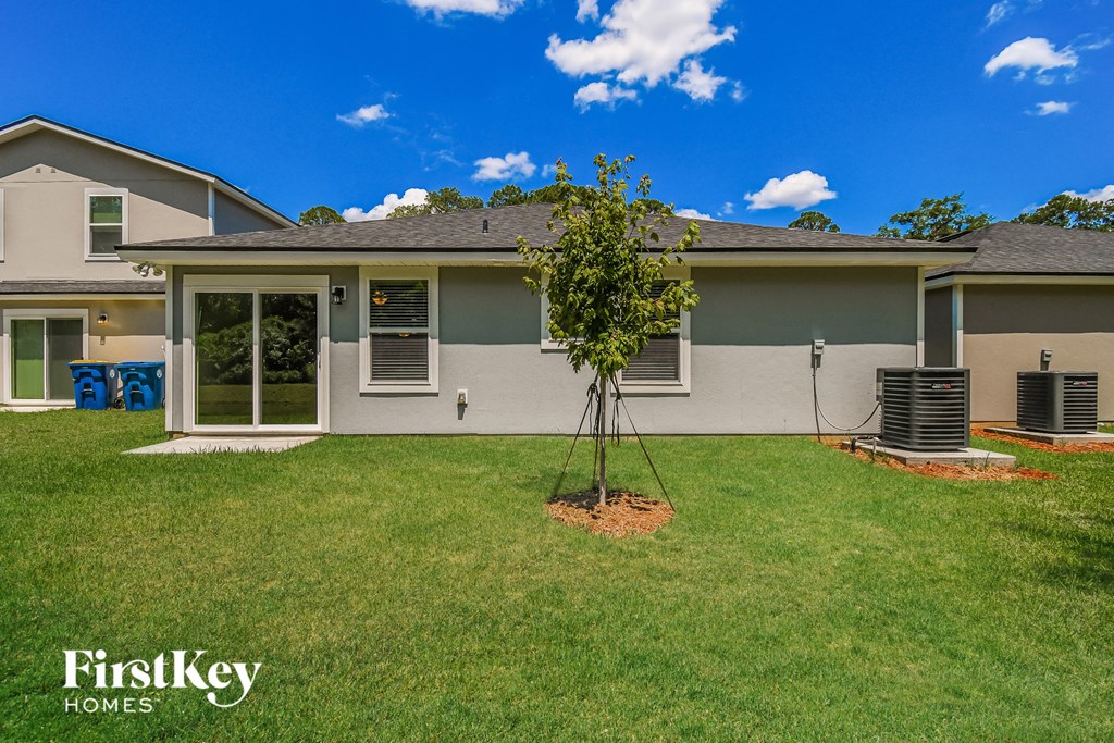 a home with a tree in the front yard