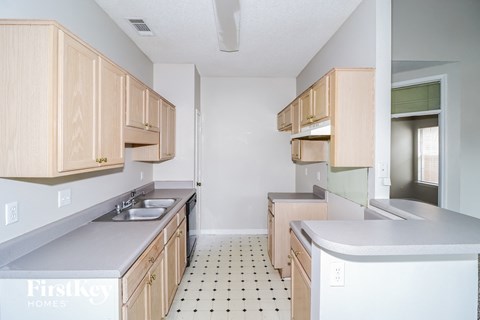 a kitchen with wooden cabinets and counter tops and a sink