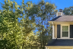 A house with a porch and a white picket fence.