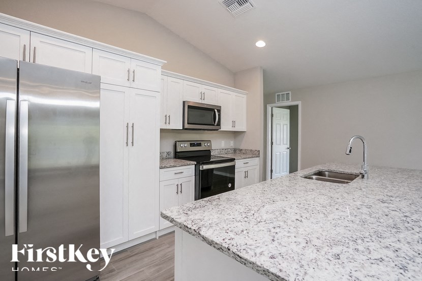 a kitchen with marble counter tops and stainless steel appliances