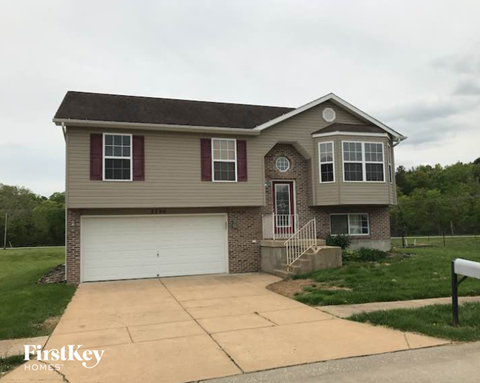 A house with a brown roof and a white garage door.