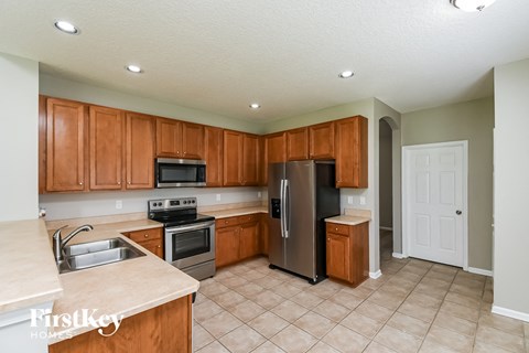 a kitchen with wooden cabinets and stainless steel appliances