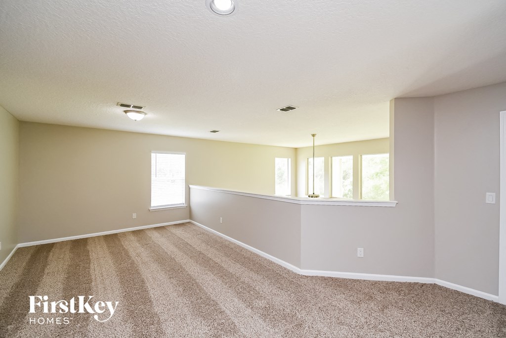 the living room and dining room of an empty house
