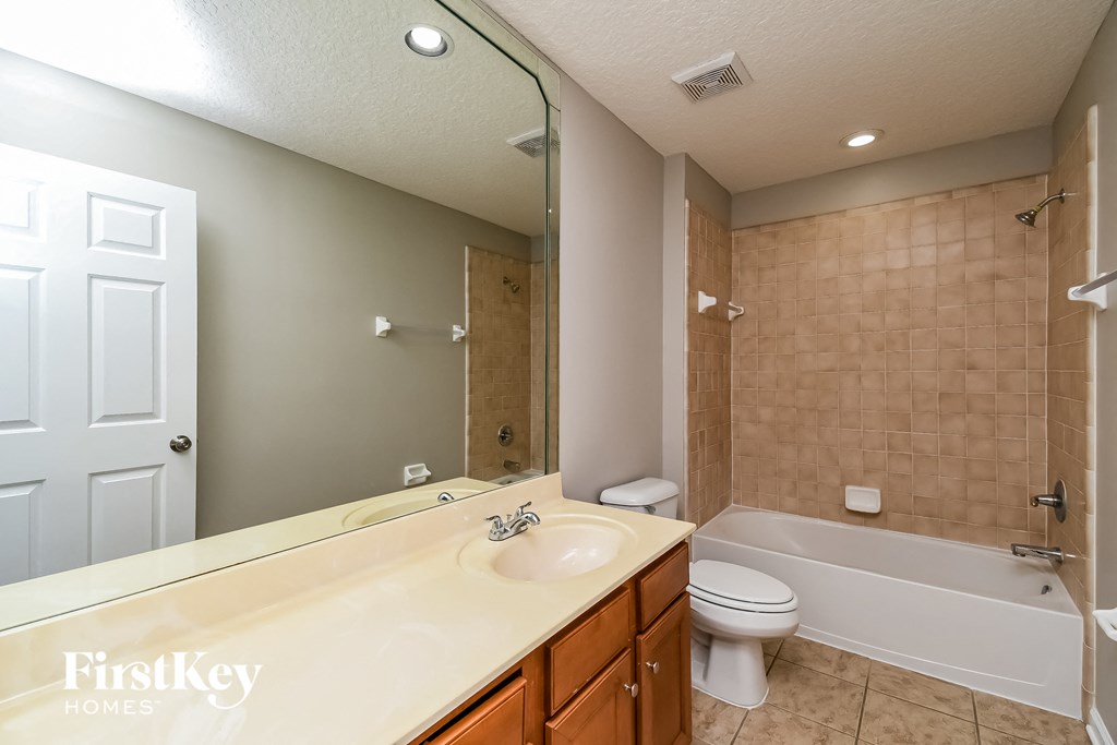 a bathroom with a sink and a toilet and a tub