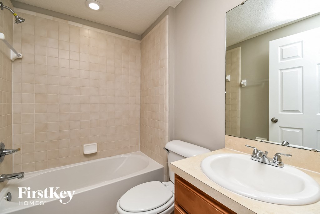 a bathroom with a sink toilet and a bath tub