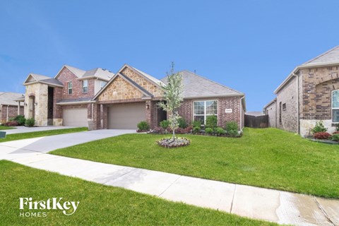 a house with a lawn and a sidewalk in front of it