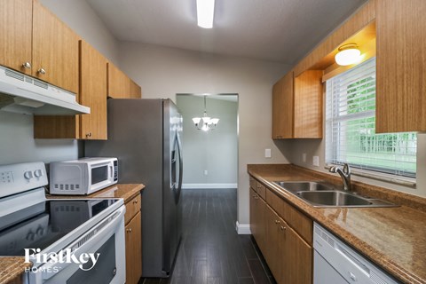 a kitchen with stainless steel appliances and wooden cabinets