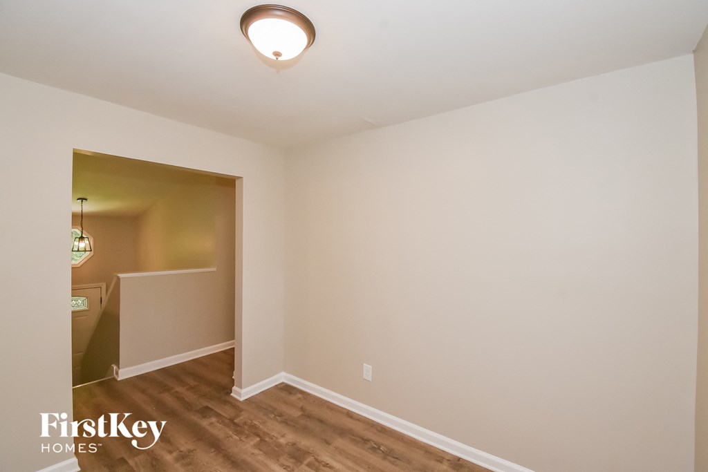 A room with a FirstKey Homes logo on the bottom left corner.