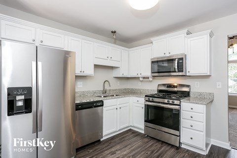 A kitchen with white cabinets and stainless steel appliances.